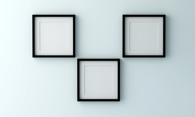 Blank black picture frame for insert text or image inside on light blue color wall.