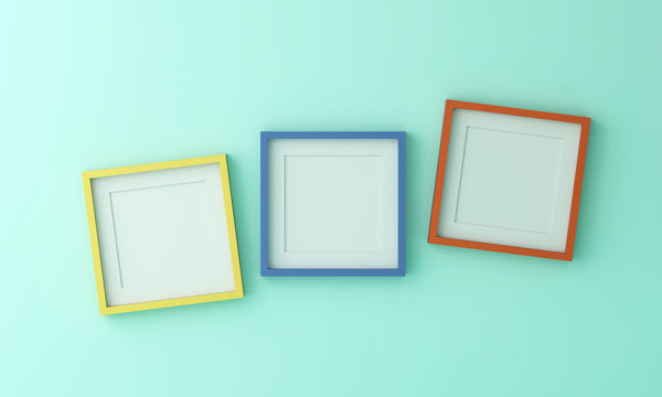 Blank Yellow Blue And Orange Picture Frame For Insert Text Or Image Inside On Green Color Wall.