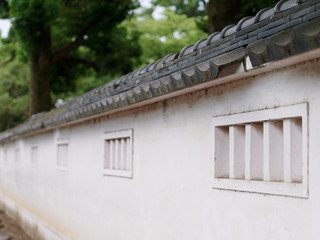 Fototapeta na wymiar Perspective view of White Japanese Castle walls and roof