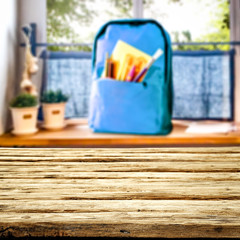 Fototapeta na wymiar table background of free space and blurred window sill with schoolbag 
