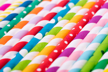 Closeup of drinking straw for party.  Top view of colorful disposable eco-friendly straw for summer cocktails. Paper coctail colorful straw on white  background, isolated.