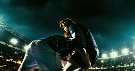 Rugby professional player is blocked with opposite player a professional sports arena with bleaches full of people. Arena and people on it are made in 3D.