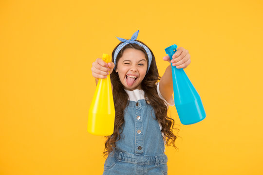 Spotless Cleaning Comes To Your Door. Little Cleaning Lady On Yellow Background. Funny Child Busy With Domestic Cleaning. Happy Small Girl Spray Household Cleaning Products