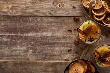 top view of traditional pear mulled wine with spices on wooden rustic table with copy space