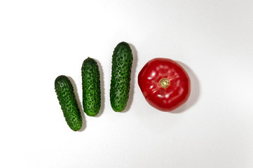 fresh tomato, lemon, cucumber lie on a white textured background
