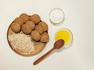 oatmeal cookies on a wooden plate with ingredients