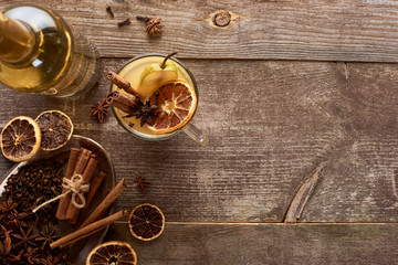 top view of traditional pear mulled wine with spices on wooden rustic table