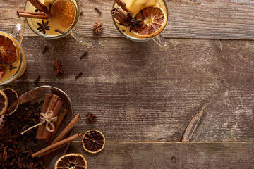 top view of traditional pear mulled wine with spices on wooden rustic table