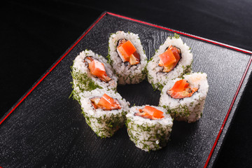 Japanese food, tasty of meal for lunch. Seafood. Sushi with eel, salmon, trout, tuna black background.