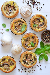 Tartlets with mushrooms and chicken on a wooden background. View from above.