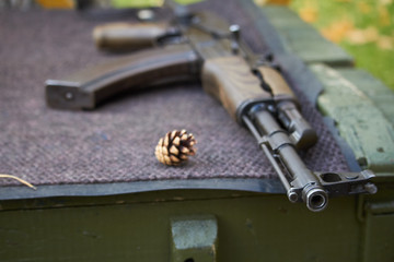 Close-up of a Kalashnikov assault rifle at a shooting range stand in an amusement park, selective...