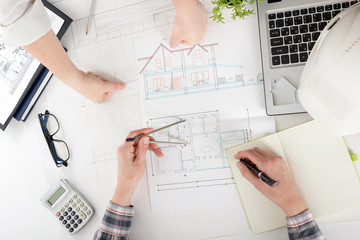 Architects working on blueprint, real estate project. Architect workplace. Construction concept....