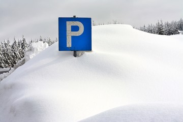 road sign buried in deep snow