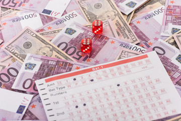 dice and betting list on euro and dollar banknotes, sports betting concept