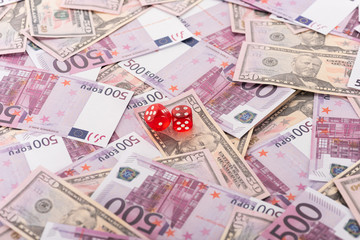 Fototapeta premium dice on euro and dollar banknotes, sports betting concept
