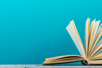 Open book, hardback books on wooden table. Back to school. Copy space