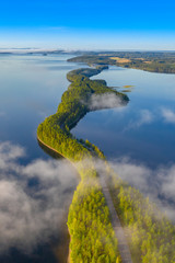 Aerial view of Pulkkilanharju Ridge, Paijanne National Park, southern part of Lake Paijanne. Landscape with drone. Fog, Blue lakes, fields and green forests from above on a sunny summer morning.