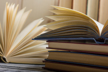 Open book, hardback books on wooden table. Back to school. Copy space