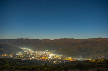 Mountain Autumn night town in the fog