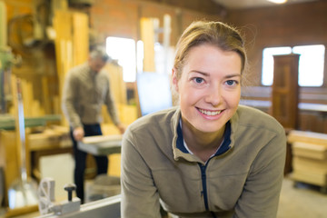Fototapeta na wymiar portrait of female carpenter in workshop