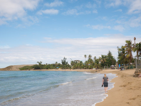 A girl walks on the Playa Jobos beach in Puerto Rico