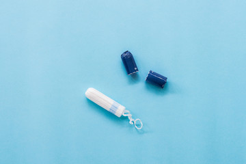 tampon and wrapper on blue background