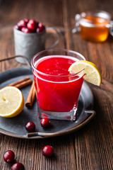 Healthy drink for urinary tract health, homemade cranberry juice with lemon and cinnamon, sweetened with honey