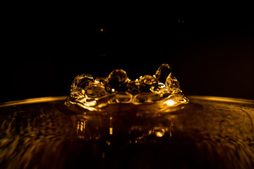 Water splash, golden water splash isolated on black background,water