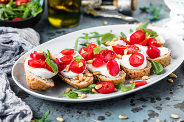 Italian bruschetta with chopped tomatoes, basil and mozzarella on grilled crusty bread