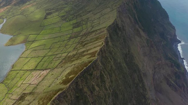 Flying through the cloud on the top of mountain. Aerial of Caldeirao volcano on Corvo island, Azores