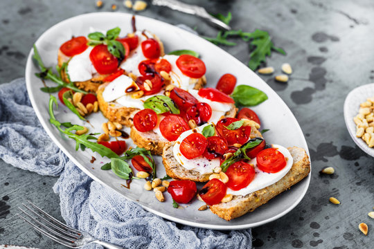 Italian bruschetta with chopped tomatoes, basil and mozzarella on grilled crusty bread