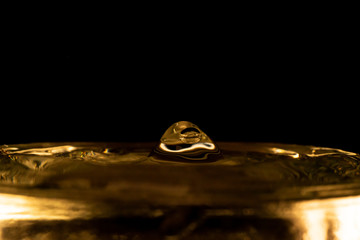 Water splash, golden water splash isolated on black background,water