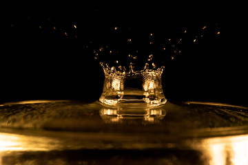 Water splash, golden water splash isolated on black background,water