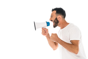 side view of angry man with clenched fist screaming in megaphone isolated on white