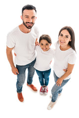 overhead view of happy parents and kid looking at camera isolated on white