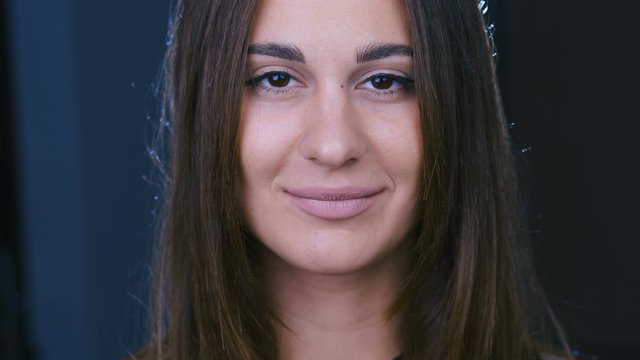 Portrait of an attractive girl close-up. Brown eyes. Slow motion. 4k