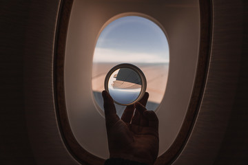 looking outside an airplane window with a crystal ball in the foreground