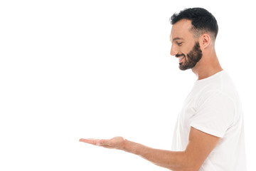 side view of handsome bearded man pointing with hand isolated on white