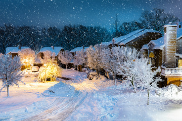 Night snowfall in a New Jersey village with wooden houses.