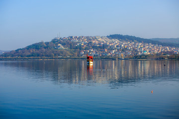red kayak, still sea, natural background