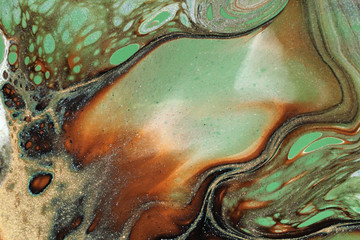 Abstract acrylic pour painting in earth tones features lacing and blending of colors to create a delicate and graceful background.
