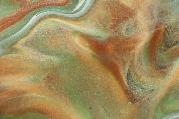 Glittering gold abounds amid shades of green and tan in this modest earth toned abstract background.