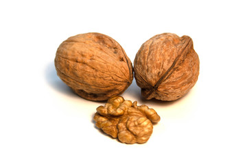 Walnuts in a shell and without it on a white background