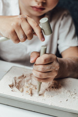 Skeleton and archaeological tools.Training for dig fossil.Simulated same as real digging. Archaeological tools, Archeaologist working on site, close-up, hand and tool. © Ekaterina