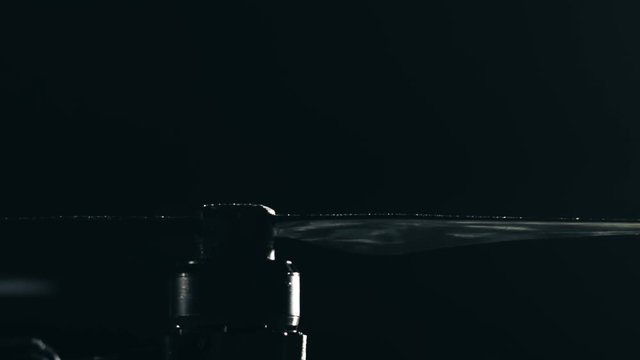 Black drone rotor stops rotation. UAV lands at night. Slow motion shot on Red camera