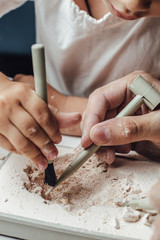 Skeleton and archaeological tools.Training for dig fossil.Simulated same as real digging. Archaeological tools, Archeaologist working on site, close-up, hand and tool. © Ekaterina