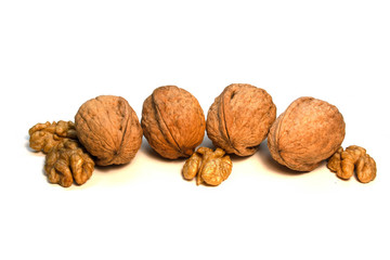 Walnuts in a shell and without it on a white background