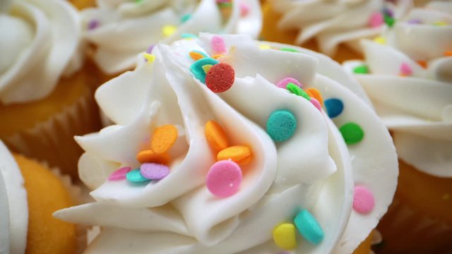 Macro Vanilla Cupcakes with Frosting and Sprinkles