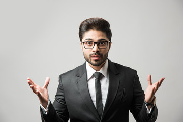 spread both hands by Indian businessman, standing isolated with wide open arms