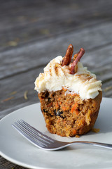 Carrot Cake Cupcake with Cream Cheese Icing with an Autumn Background
